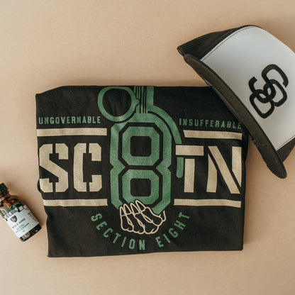 Section Eight branded towel, cap, and bottle on a beige background