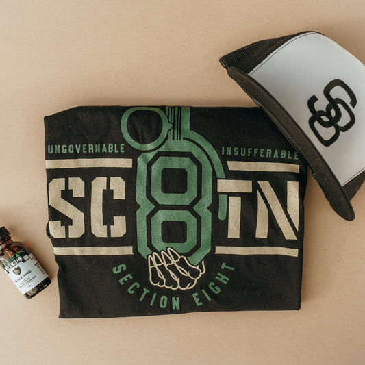 Section Eight branded towel, cap, and bottle on a beige background